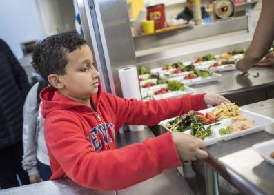 Member picking up tray of healthy food